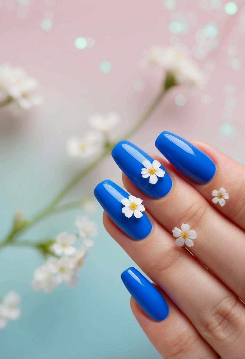 Blue nails adorned with delicate white flowers against a pastel background